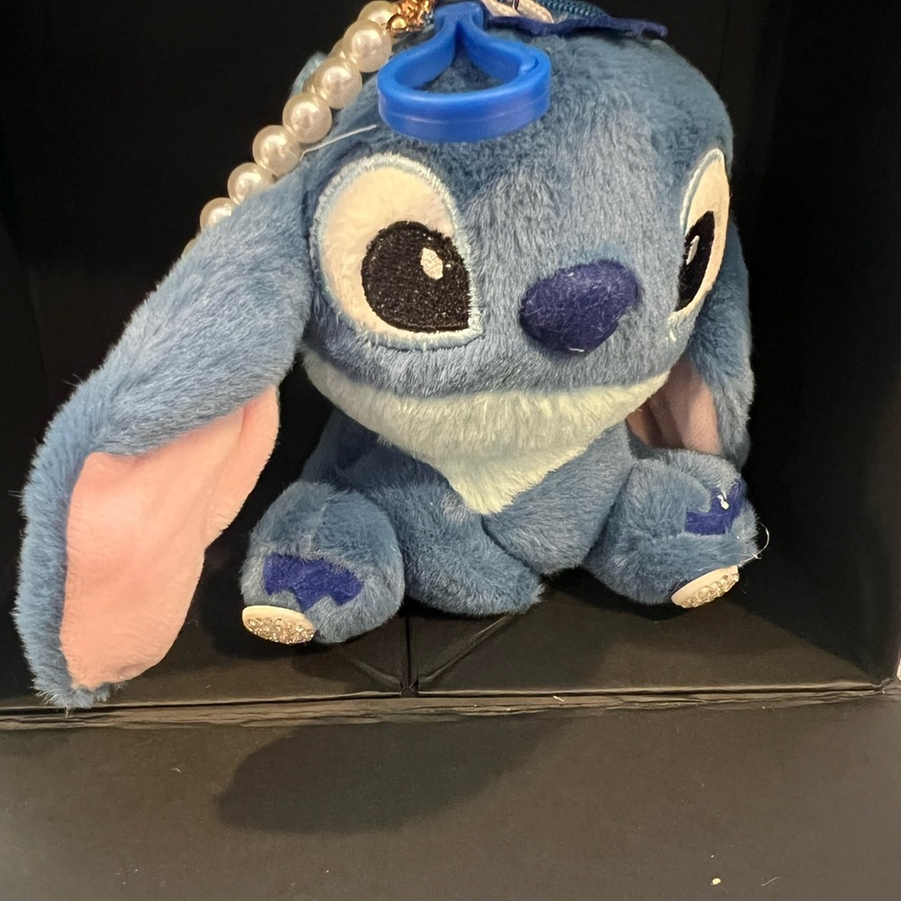 Adorable stitch keychain with coin compartment.